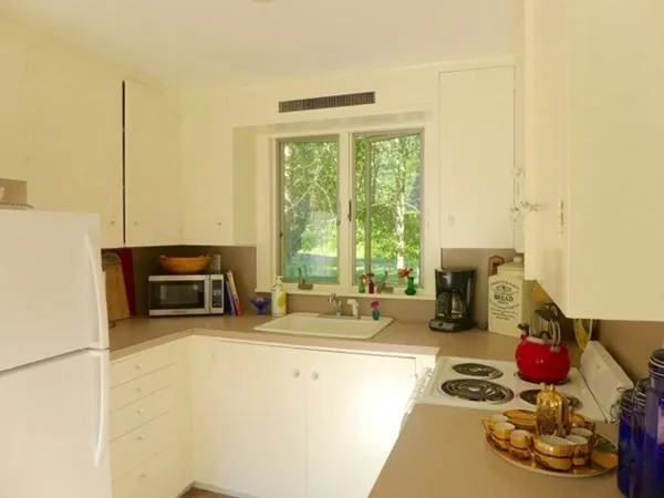 a kitchen with a stove a sink and a cabinets