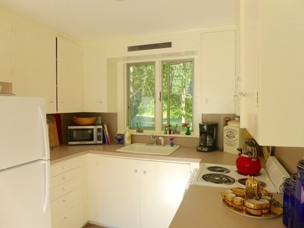141 N Road Chilmark, MA 02535 - Photo 4 of 9 a kitchen with a stove a sink and a cabinets