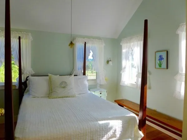 a bedroom with a bed and a mirror