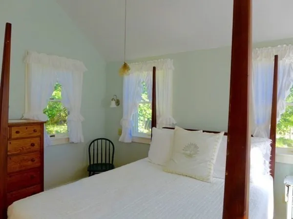 a bedroom with a bed and with furniture