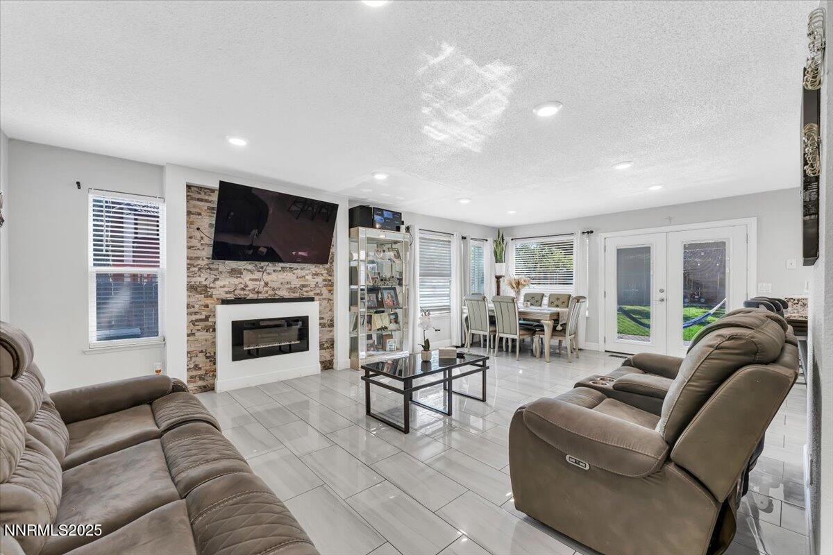 7194 Indigo Court Reno, NV 89506 - Photo 3 of 33 a living room with furniture fireplace and flat screen tv