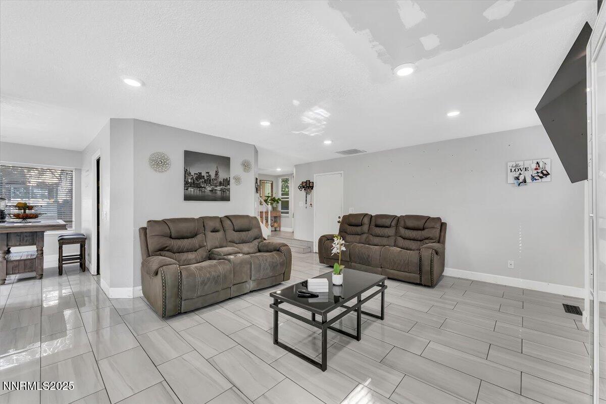 7194 Indigo Court Reno, NV 89506 - Photo 5 of 33 a living room with furniture and a flat screen tv