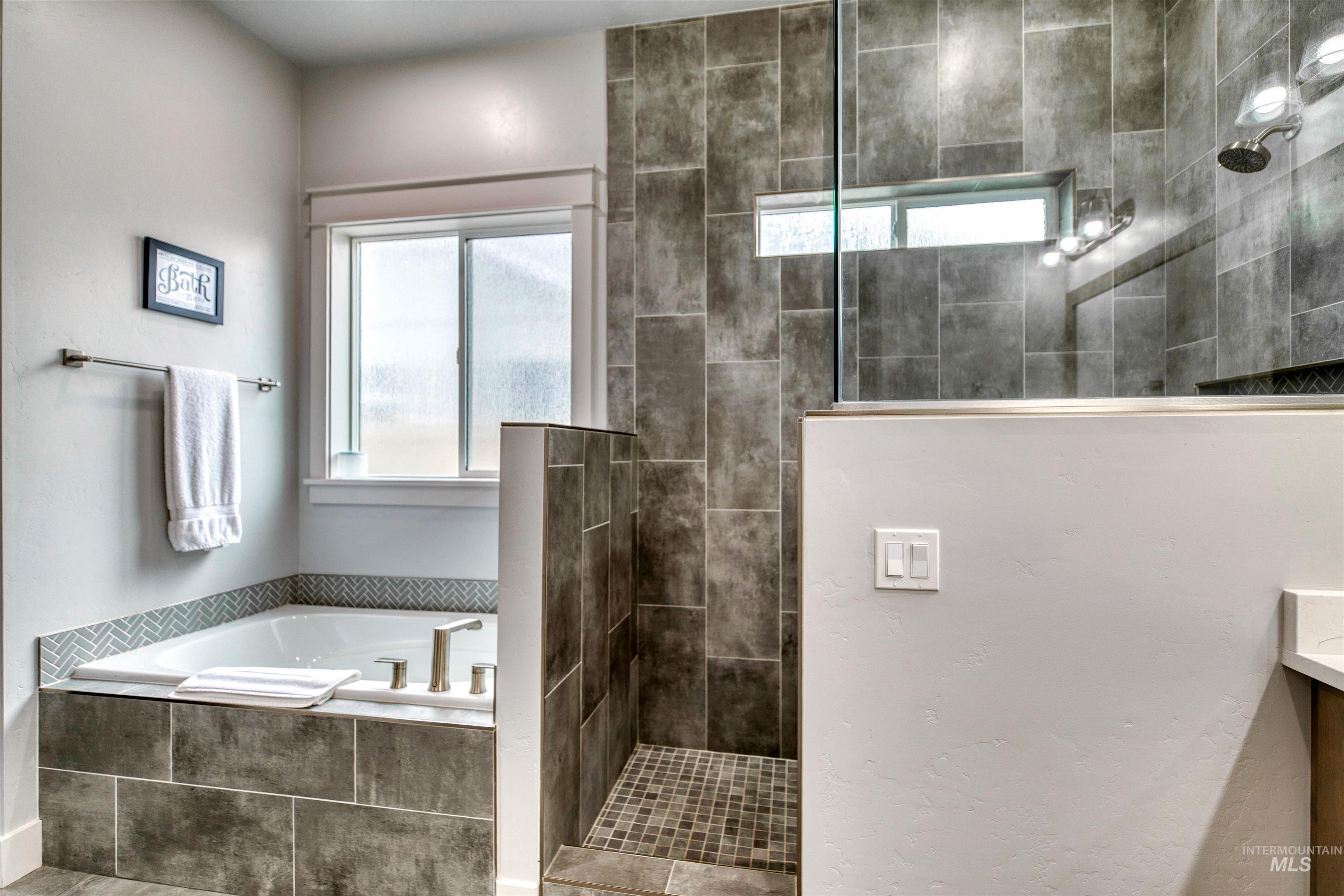 795 East Rio Chico Drive Kuna, ID 83634 - Photo 18 of 34 Bathroom featuring plenty of natural light, walk in shower, and a bath