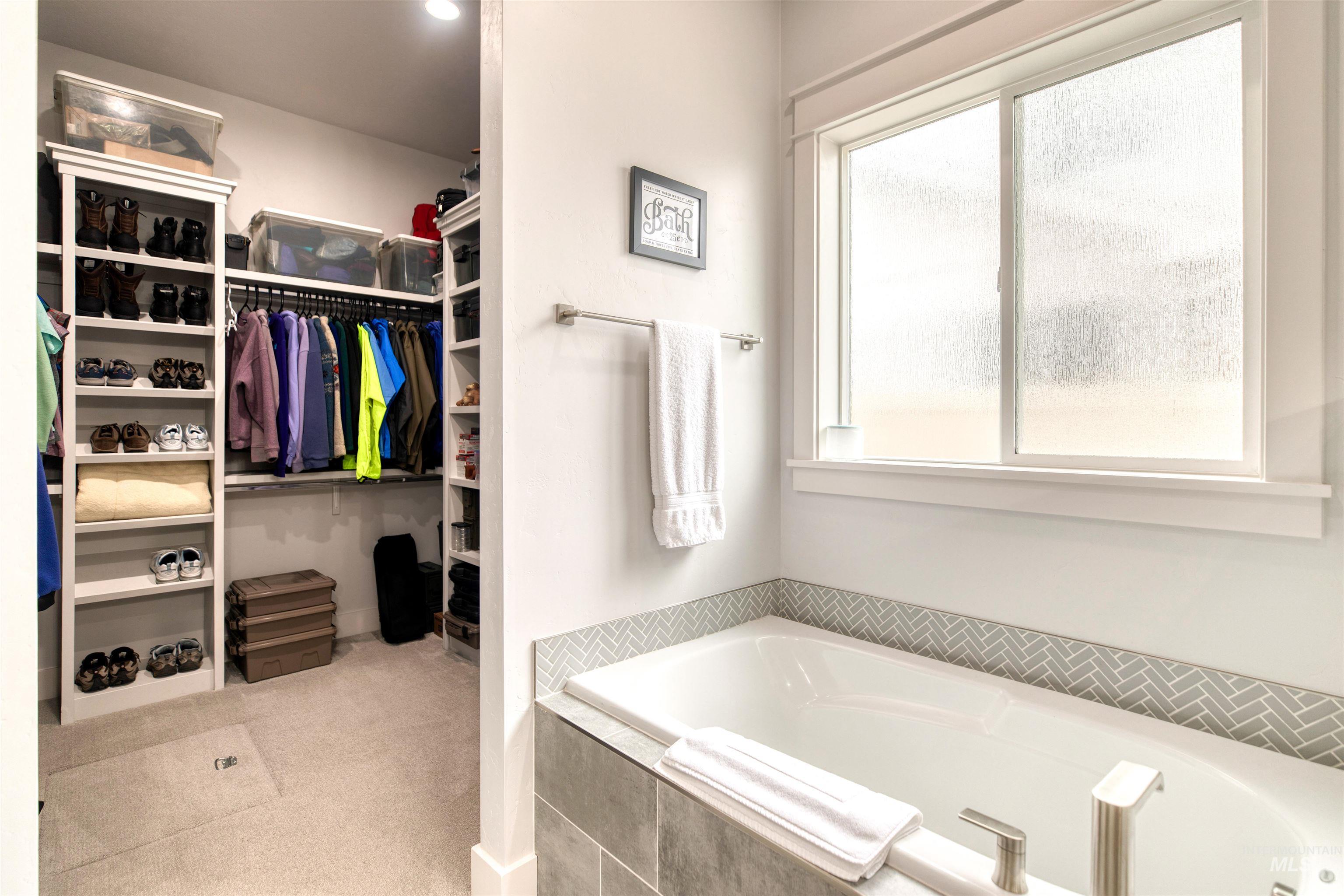 795 East Rio Chico Drive Kuna, ID 83634 - Photo 19 of 34 Full bath featuring a bath, light colored carpet, and a spacious closet