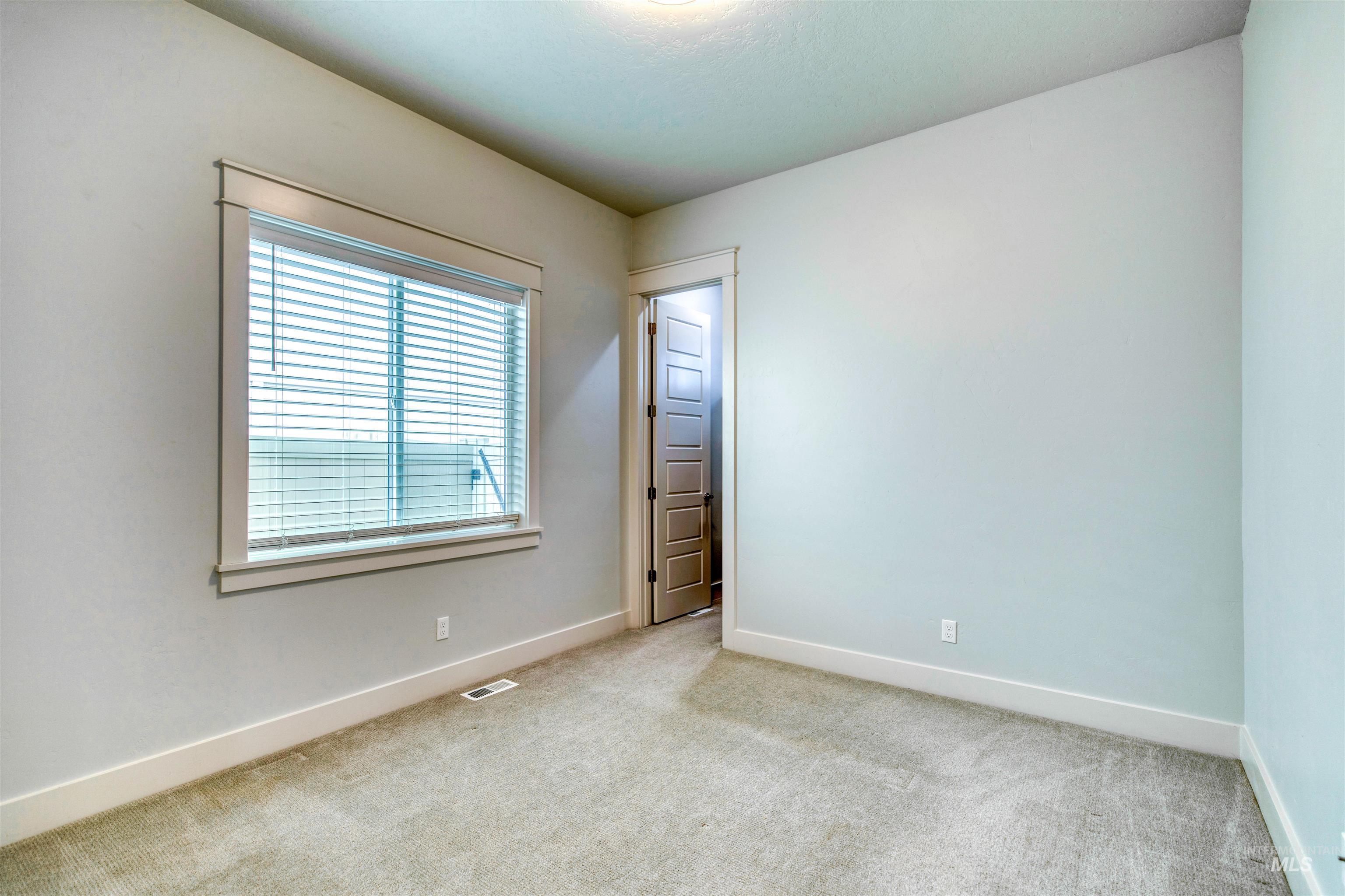 795 East Rio Chico Drive Kuna, ID 83634 - Photo 22 of 34 Spare room with light colored carpet and baseboards