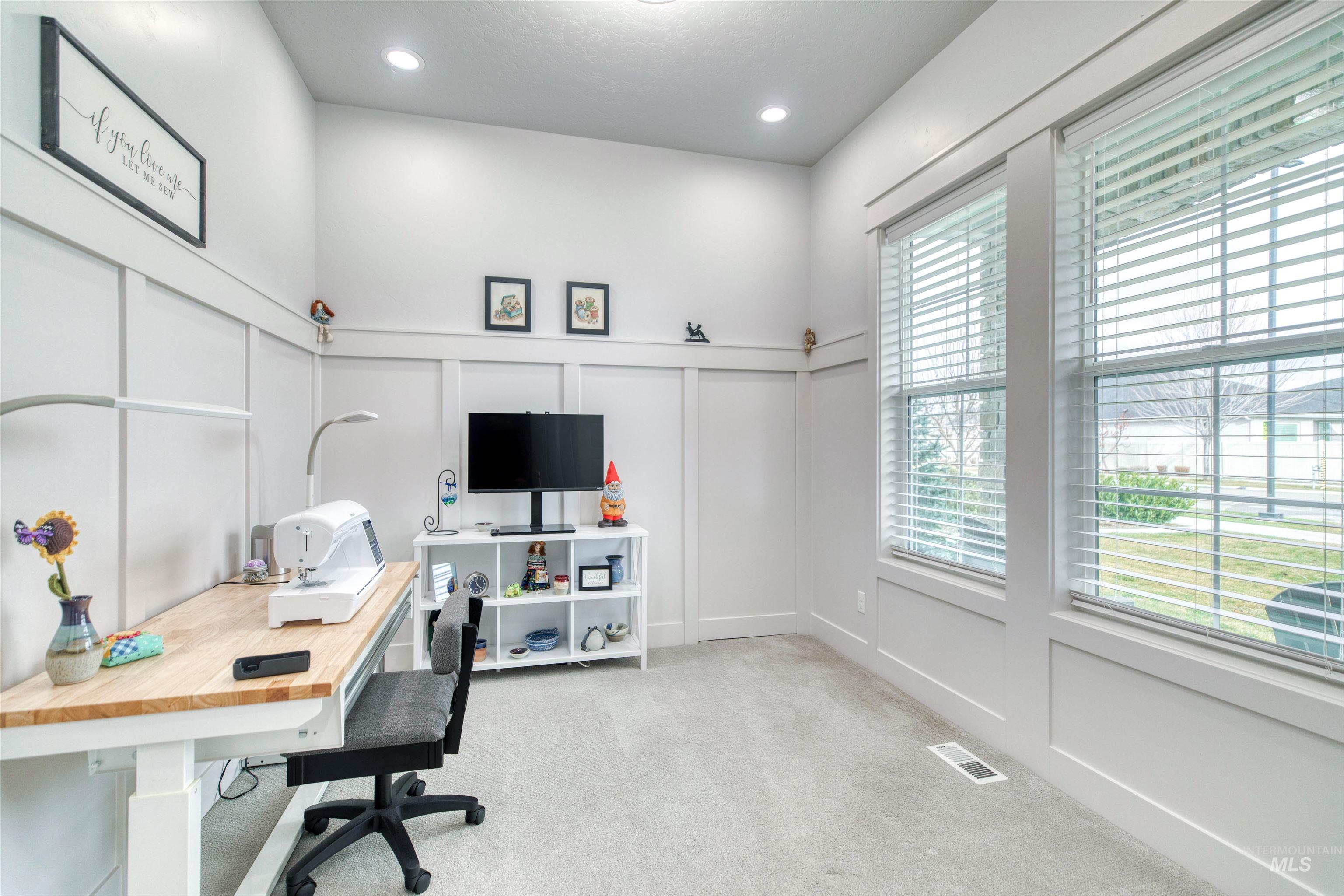 795 East Rio Chico Drive Kuna, ID 83634 - Photo 23 of 34 Office area with a decorative wall, a wainscoted wall, and light colored carpet