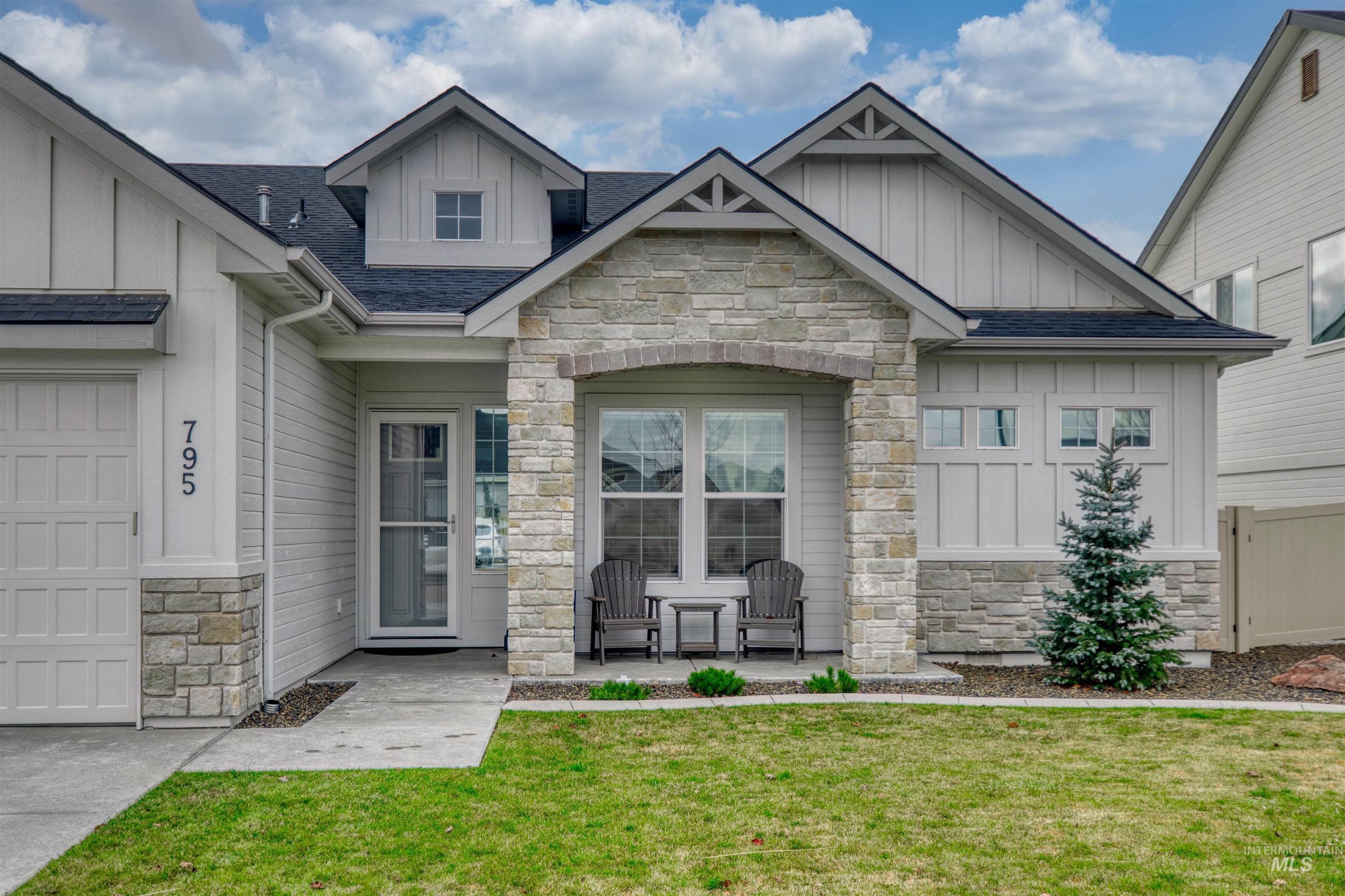 795 East Rio Chico Drive Kuna, ID 83634 - Photo 3 of 34 Property entrance featuring board and batten siding, stone siding, and roof with shingles