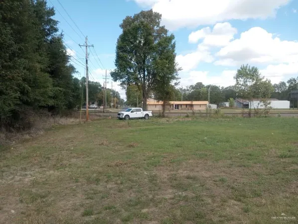 a view of outdoor space with green field and trees