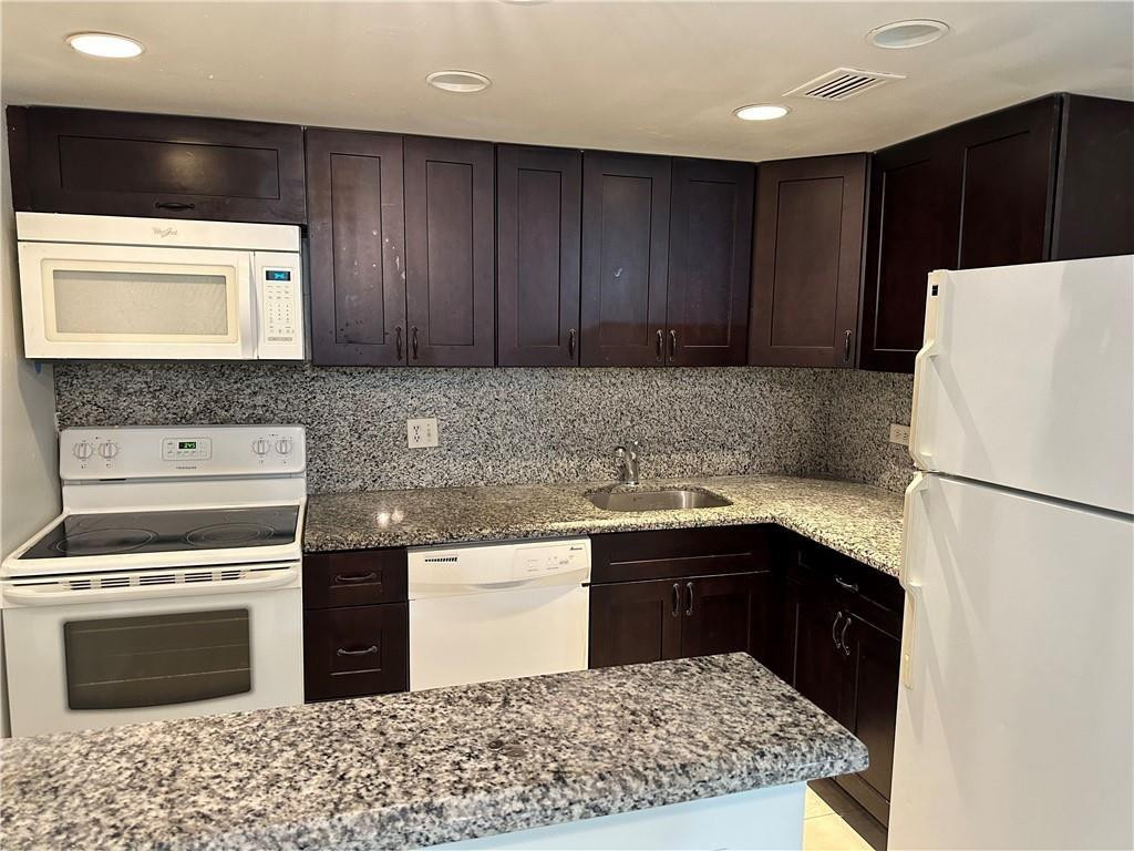 a kitchen with a cabinets and white appliances