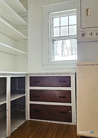 a view of walk in closet with empty racks