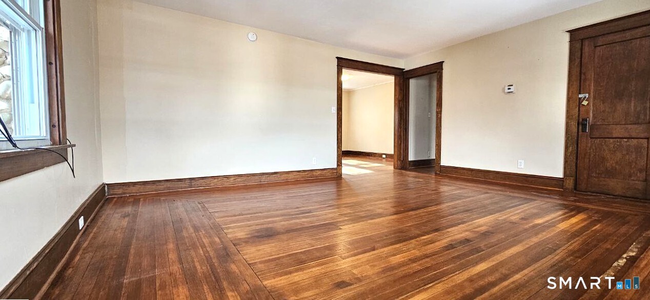 49 Bingham Street Bristol, CT 06010 - Photo 15 of 27 a view of an empty room with wooden floor and a window