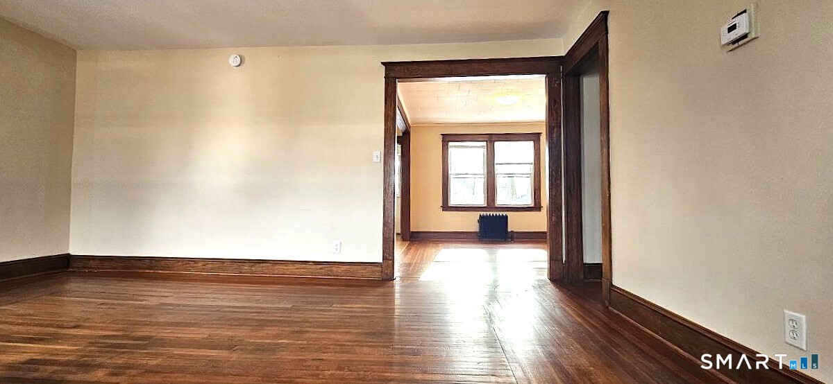 49 Bingham Street Bristol, CT 06010 - Photo 17 of 27 a view of empty room with wooden floor and fan