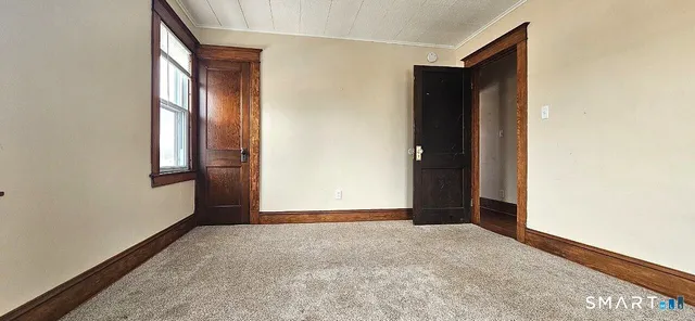 an empty room with windows and closet