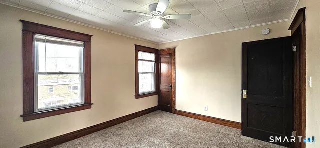 an empty room with windows and closet