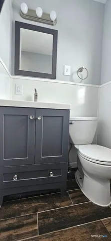 a bathroom with a toilet sink and mirror