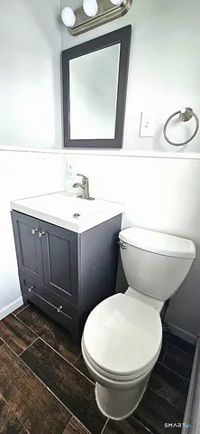 a bathroom with a toilet sink and mirror