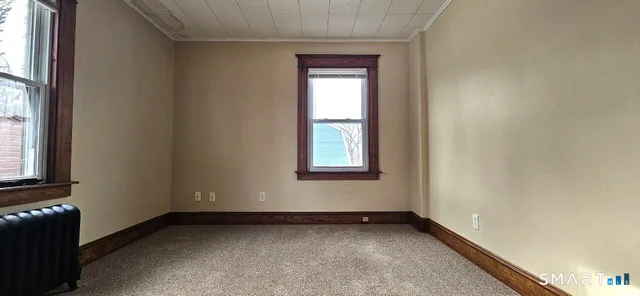 a view of an empty room with a window