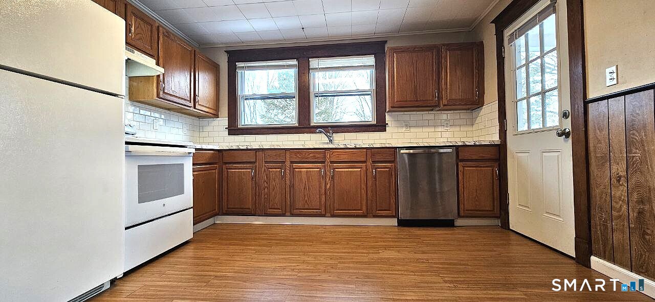49 Bingham Street Bristol, CT 06010 - Photo 9 of 27 a kitchen with stainless steel appliances granite countertop a stove a sink and a refrigerator