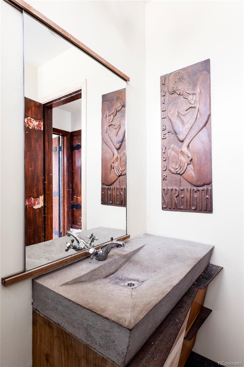 3025 Glencoe Street Denver, CO 80207 - Photo 11 of 26 a bathroom with a sink and a mirror