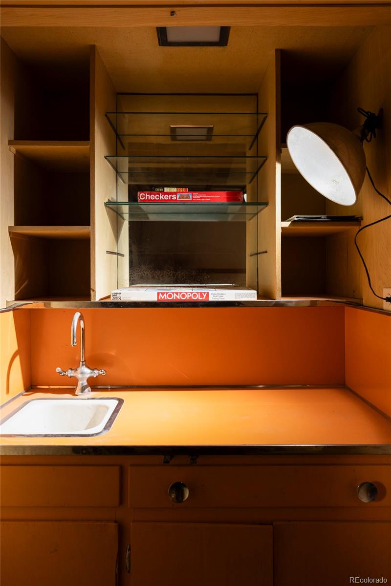 3025 Glencoe Street Denver, CO 80207 - Photo 18 of 26 a bathroom with a sink and a mirror
