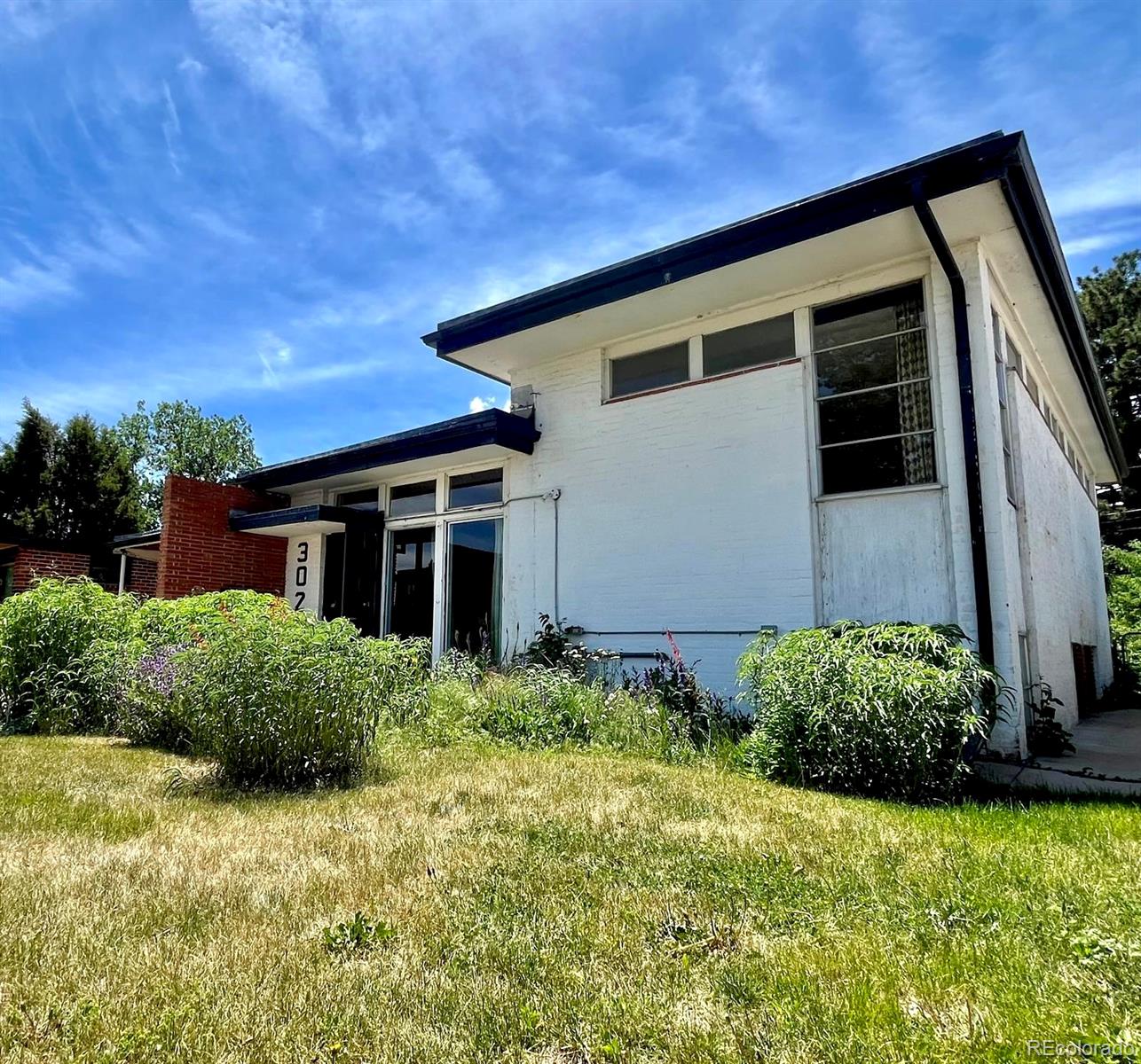 3025 Glencoe Street Denver, CO 80207 - Photo 21 of 26 a house with garden in front of it