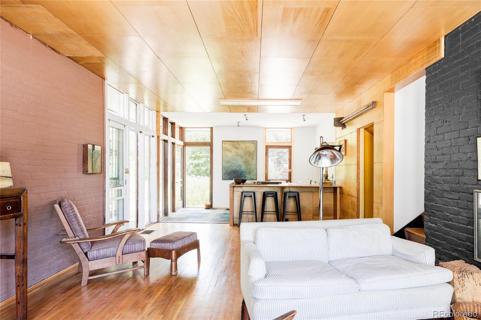 3025 Glencoe Street Denver, CO 80207 - Photo 3 of 26 a living room with furniture and a large window