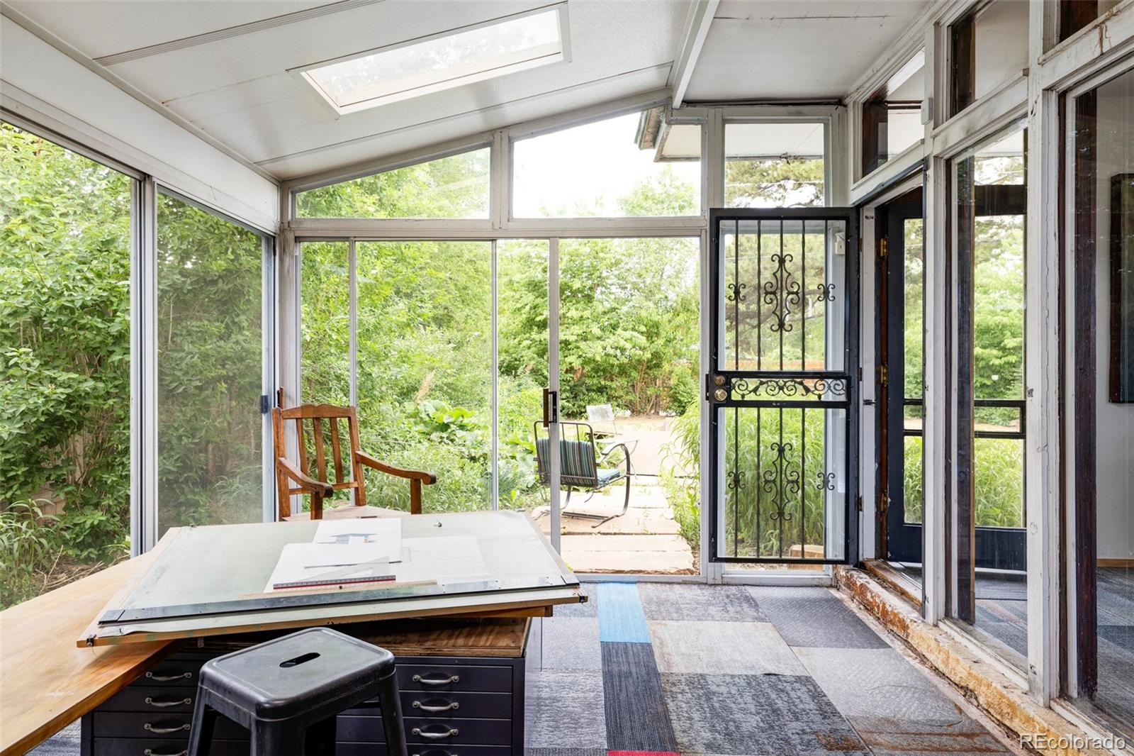 3025 Glencoe Street Denver, CO 80207 - Photo 7 of 26 a view of a patio with table and chairs next to a yard