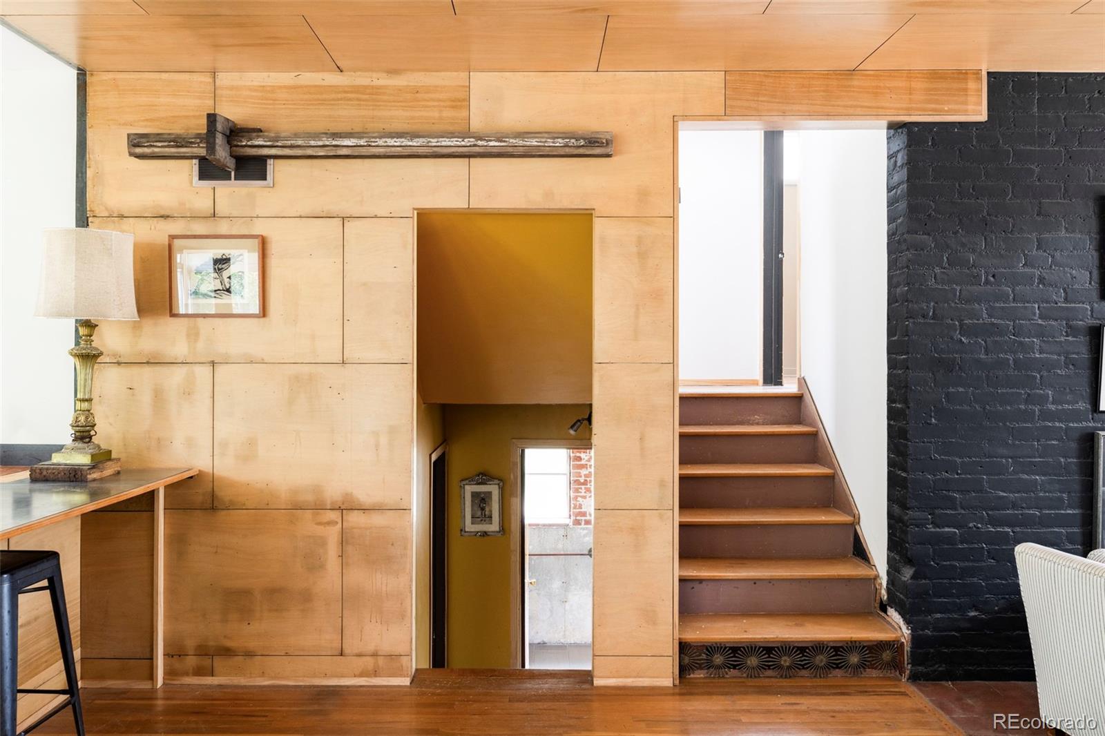 3025 Glencoe Street Denver, CO 80207 - Photo 8 of 26 a view of a balcony with wooden floor and windows