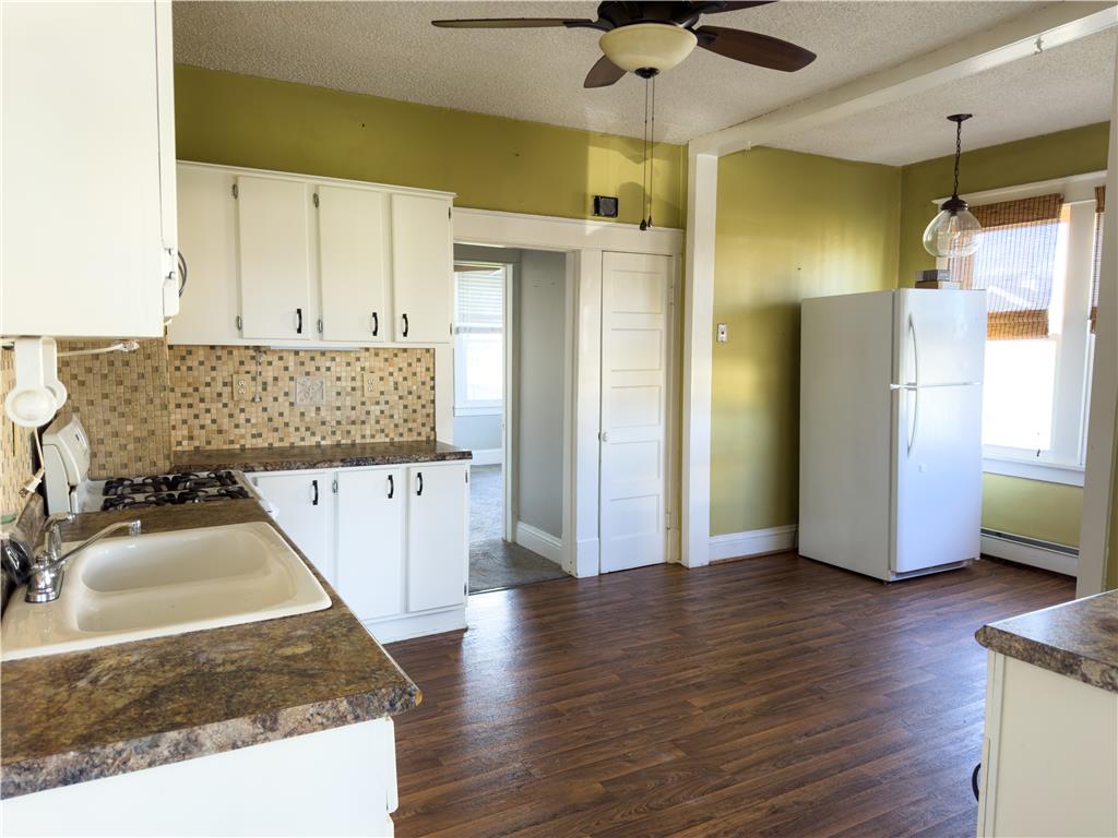 870 Chestnut Street Coplay, PA 18037 - Photo 5 of 24 A functional kitchen with wood-look flooring and ample cabinetry provides a comfortable cooking space.