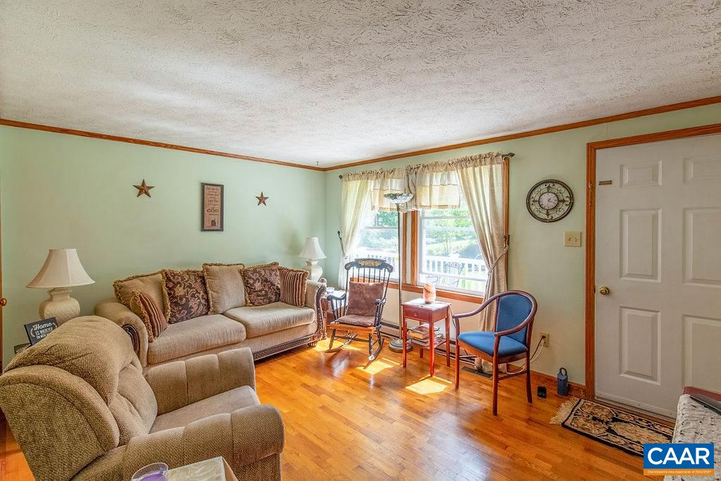7219 Amicus Road Ruckersville, VA 22968 - Photo 16 of 35 a living room with furniture and wooden floor