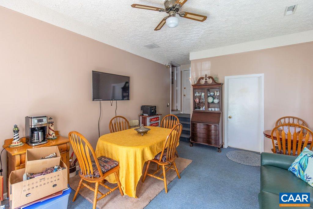 7219 Amicus Road Ruckersville, VA 22968 - Photo 23 of 35 a dining room with furniture and a flat screen tv