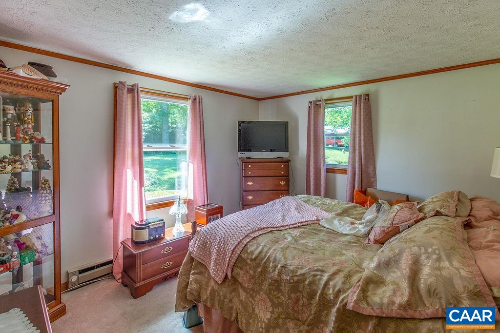 7219 Amicus Road Ruckersville, VA 22968 - Photo 27 of 35 a bedroom with a bed and large windows