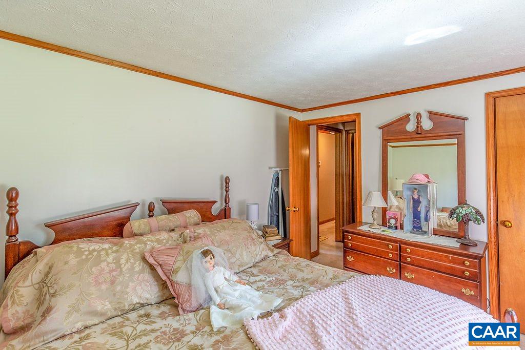 7219 Amicus Road Ruckersville, VA 22968 - Photo 28 of 35 a bedroom with a bed and large windows