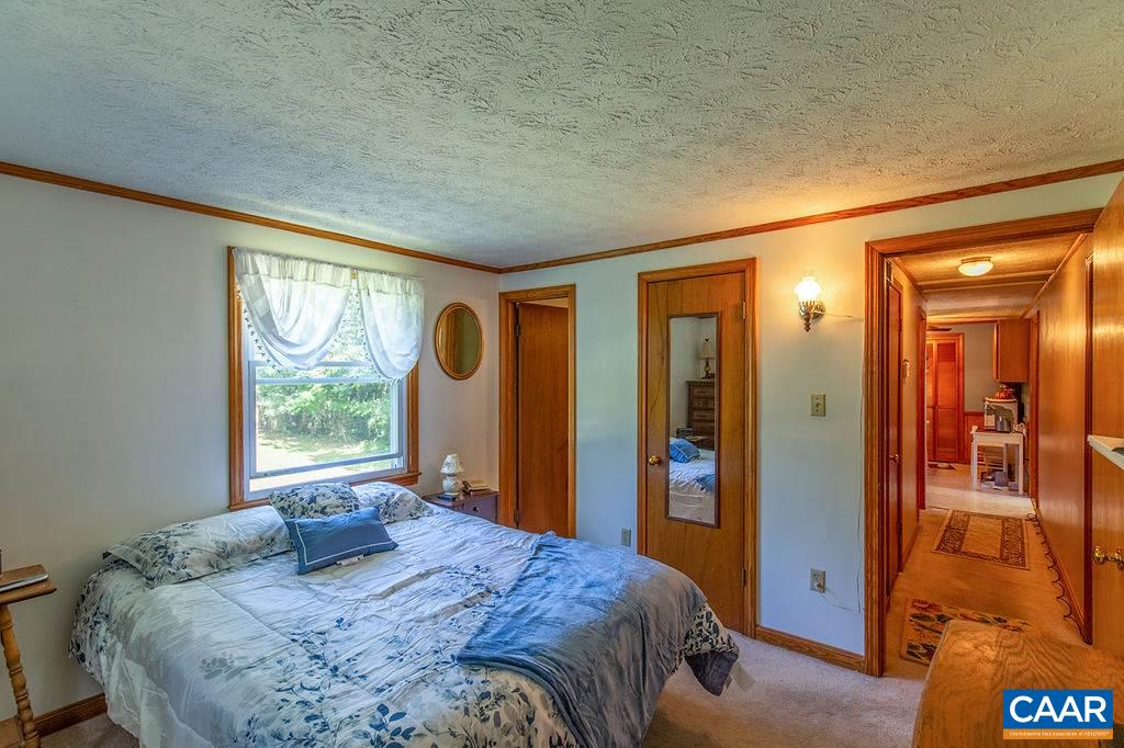 7219 Amicus Road Ruckersville, VA 22968 - Photo 31 of 35 a bedroom with a bed and a window