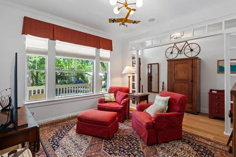 a living room with furniture a chandelier and a window