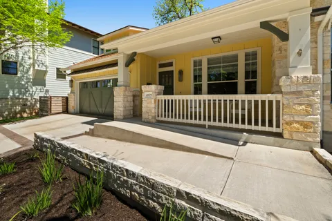 a view of a house with a wooden fence