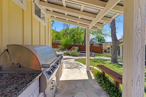 a view of a backyard with garden and patio
