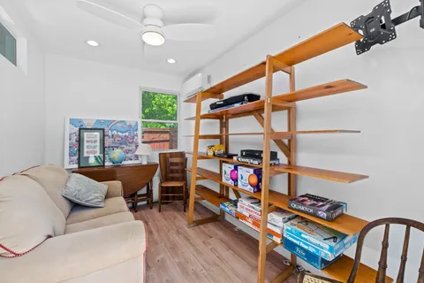 a bedroom with furniture and a large window