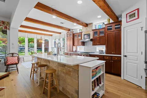 a kitchen with stainless steel appliances granite countertop a stove and a refrigerator