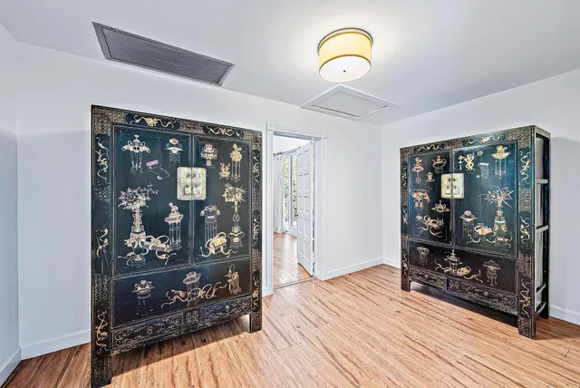 a view of a hallway with wooden floor windows and entryway