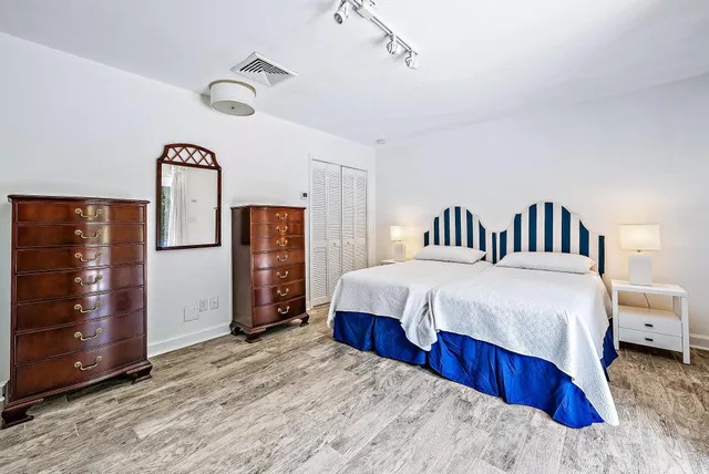 a bedroom with bed and wooden floor