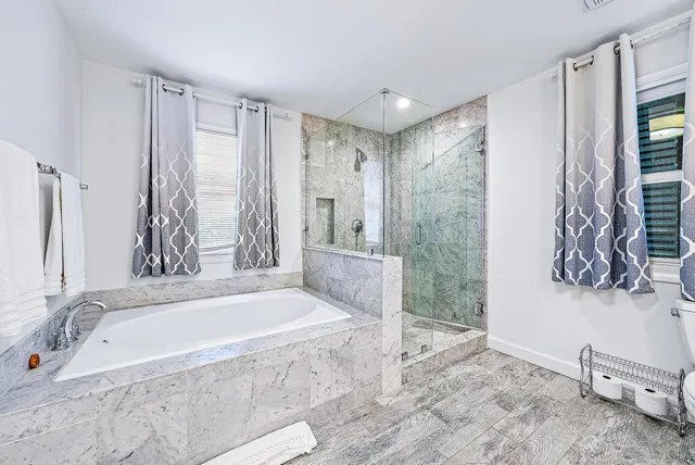 a spacious bathroom with a tub and a shower