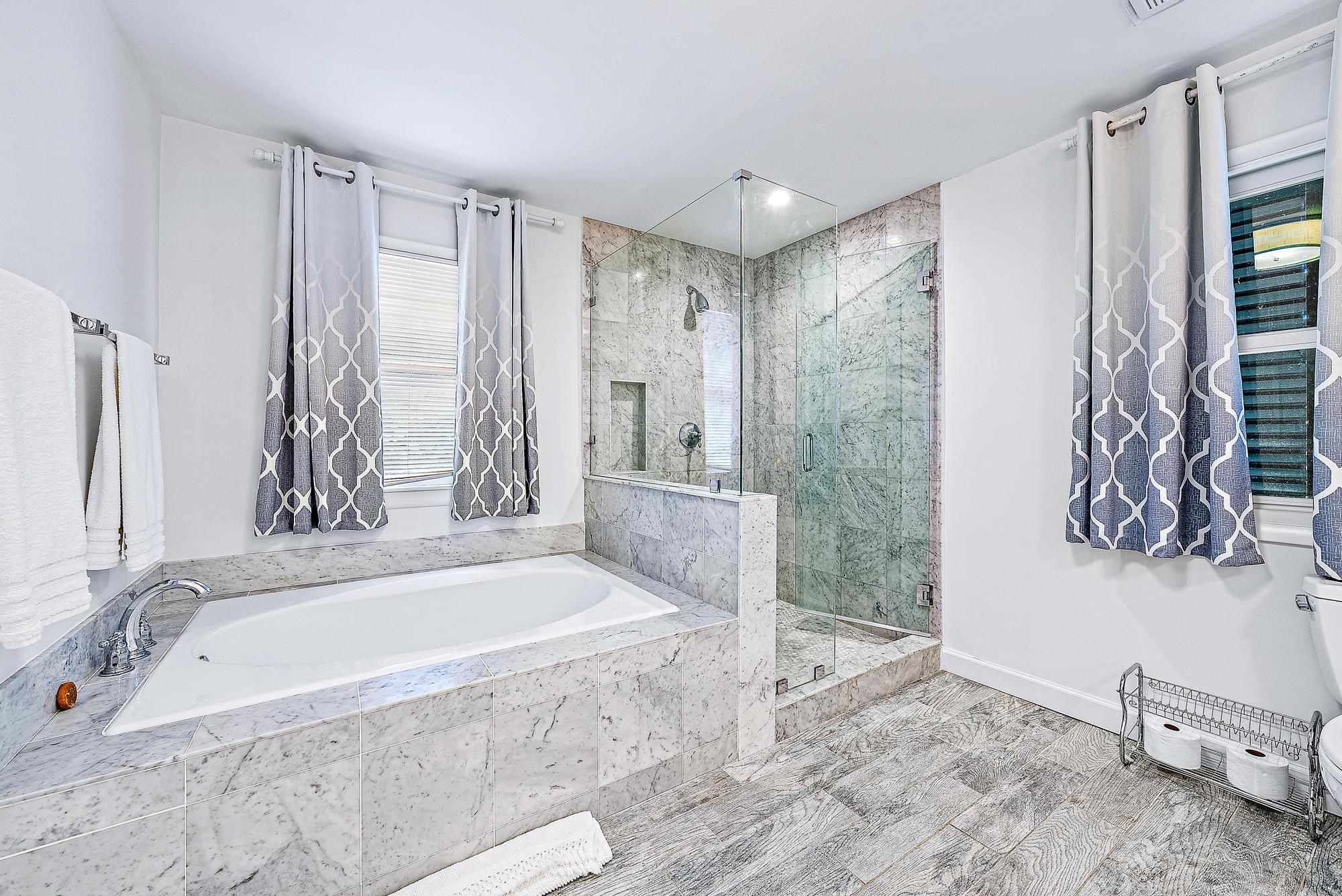 5 North Beach Road Jupiter Island, FL 33455 - Photo 17 of 33 a spacious bathroom with a tub and a shower