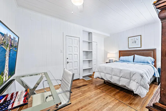 a bedroom with a bed and a book shelf