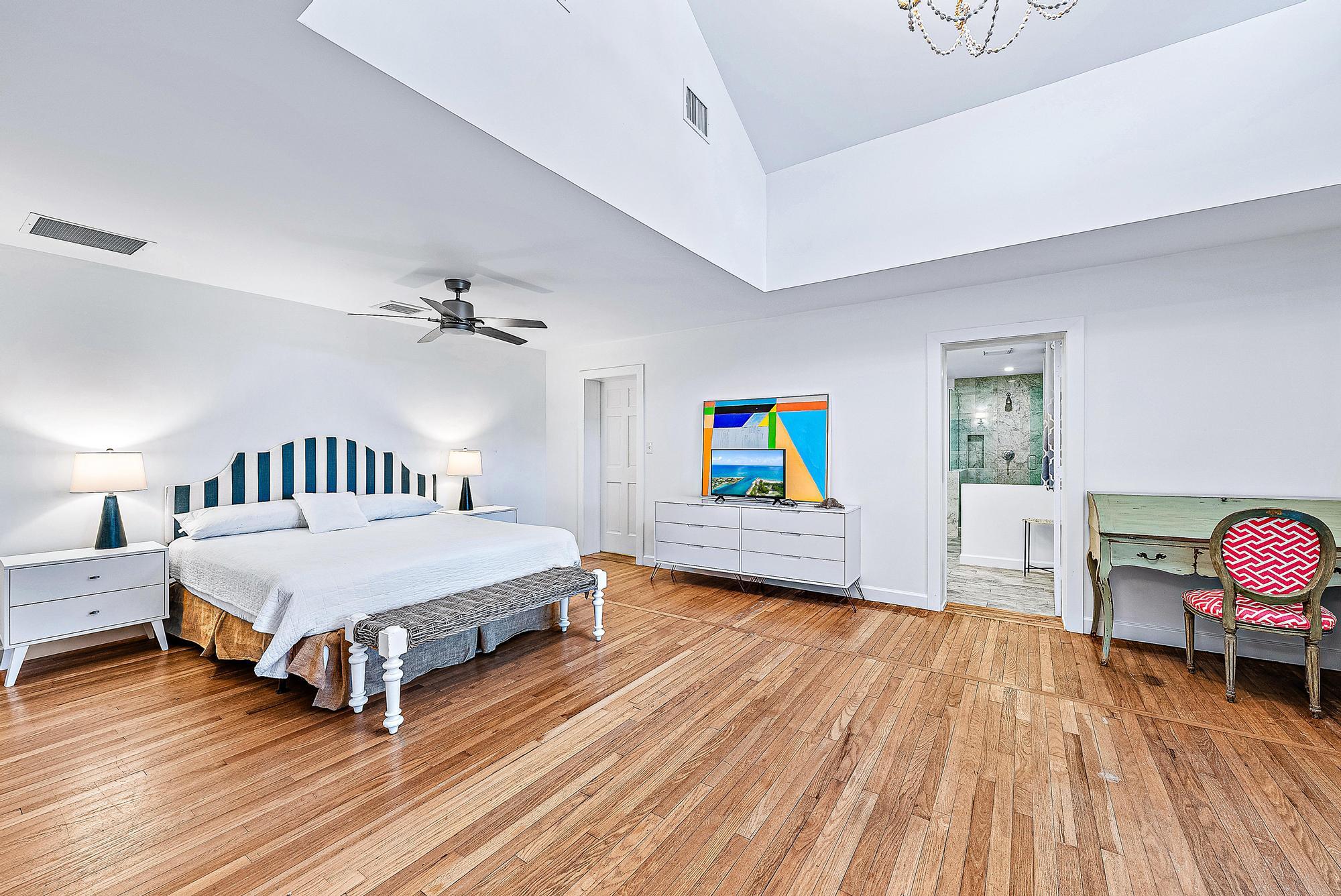 5 North Beach Road Jupiter Island, FL 33455 - Photo 27 of 33 a spacious bedroom with a bed and wooden floor