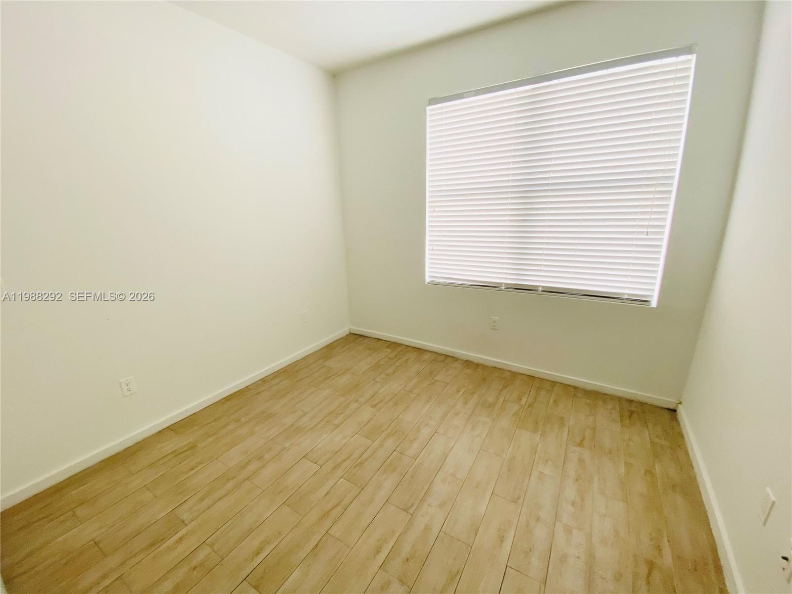 1611 Meridian Avenue, Unit 305 Miami Beach, FL 33139 - Photo 11 of 17 an empty room with a window