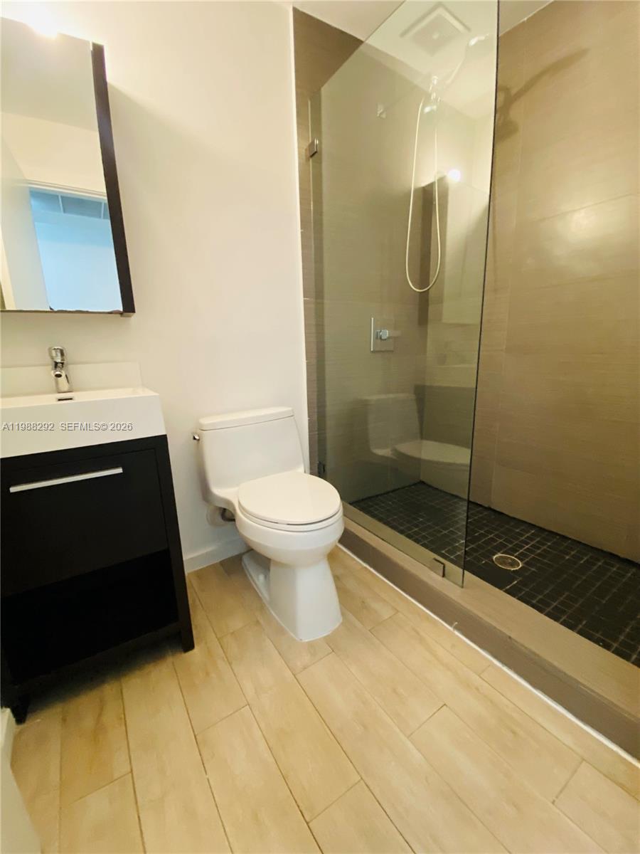 1611 Meridian Avenue, Unit 305 Miami Beach, FL 33139 - Photo 13 of 17 a bathroom with a sink toilet and shower