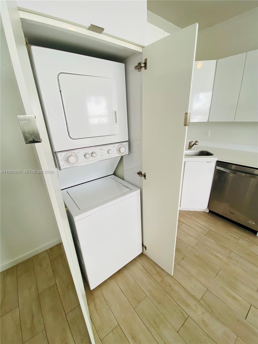 1611 Meridian Avenue, Unit 305 Miami Beach, FL 33139 - Photo 6 of 17 a utility room with dryer and washer
