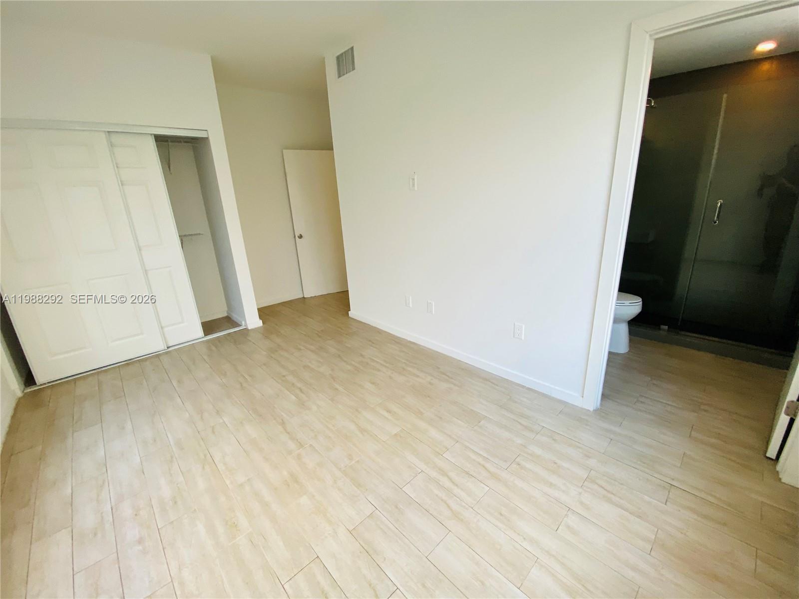 1611 Meridian Avenue, Unit 305 Miami Beach, FL 33139 - Photo 9 of 17 an empty room with wooden floor