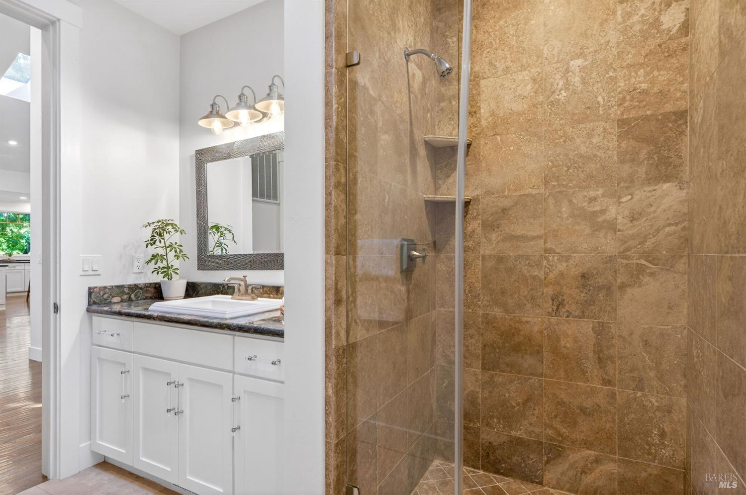 3425 Redwood Road Napa, CA 94558 - Photo 28 of 38 a bathroom with a shower sink and mirror